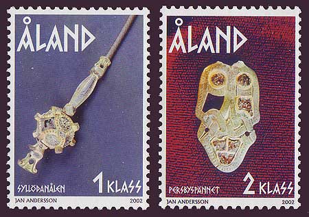 Aland set of 2 showing ancient ornaments, buckle and pin.