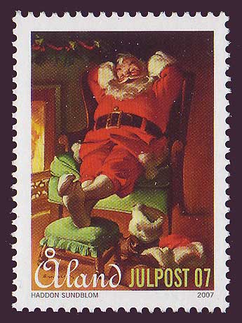 Aland stamp showing Santa relaxing by the fire.
