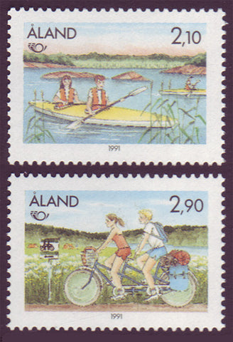 aland set of 2 stamps showing boy and girl kayaking and bicycling.